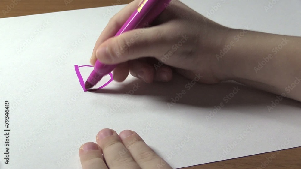 The child learns to write the word DAD. Close-up. The child learns to write the word DAD. Close-up.