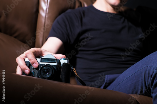 Young man with old camera