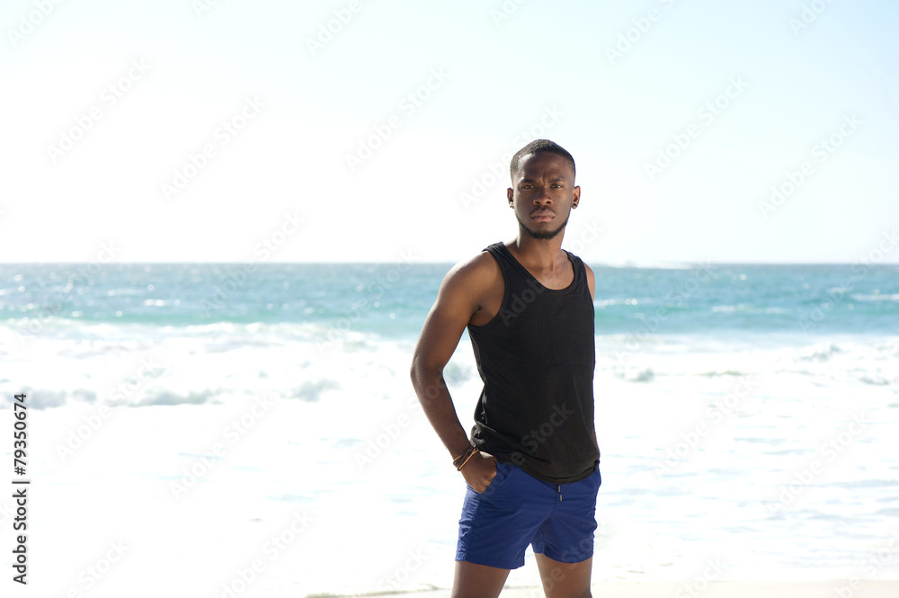 Handsome young african american man standing at the beach Handsome young african american man standing at the beach