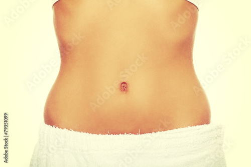 Fit and slim young woman's belly. © Piotr Marcinski