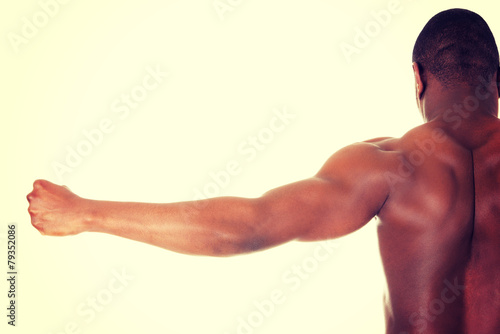 Casual young african man showing his muscles