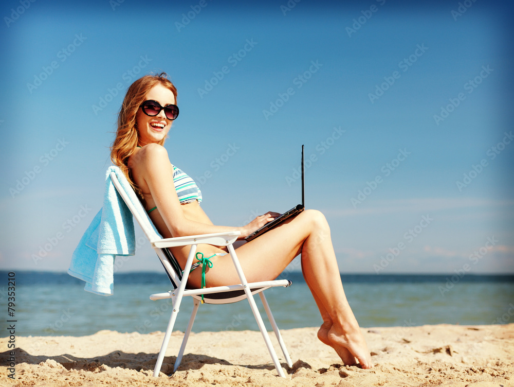 girl looking at tablet pc on the beach