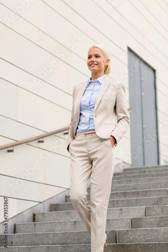 Wallpaper Mural young smiling businesswoman walking down stairs Torontodigital.ca