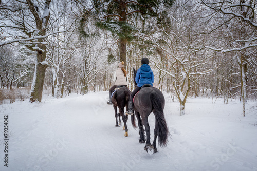 Horse riders at snowy weather