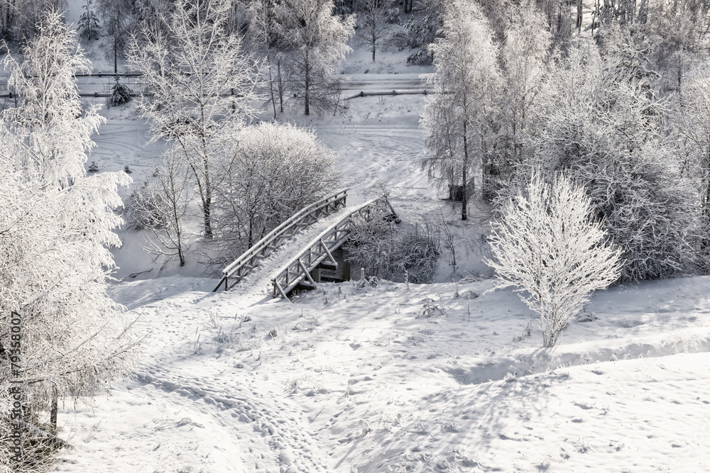 Snowy, wooden bridge in a winter day. View from above.