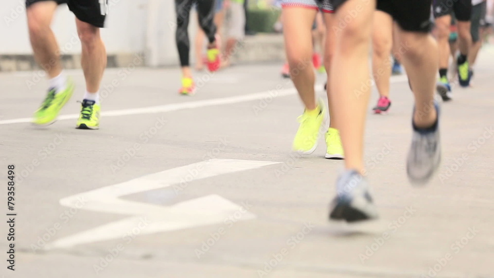 Marathon runners legs on the street Marathon runners legs on the street