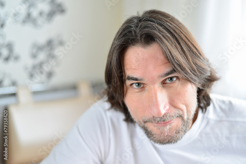 Portrait of man sitting in living room