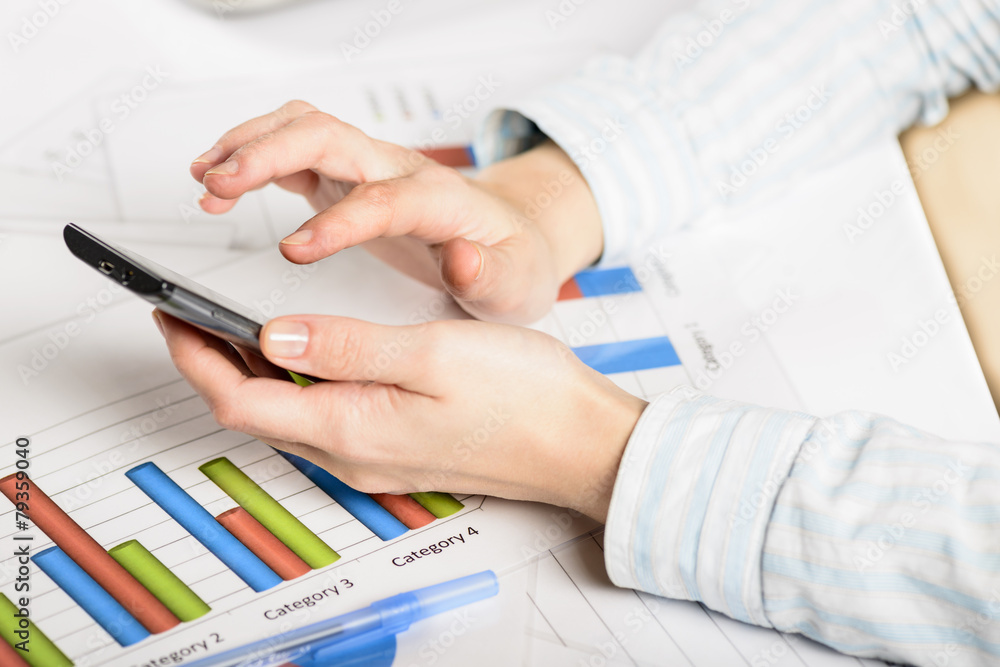 Fototapeta premium Businesswoman hands analyzing financial statistics.