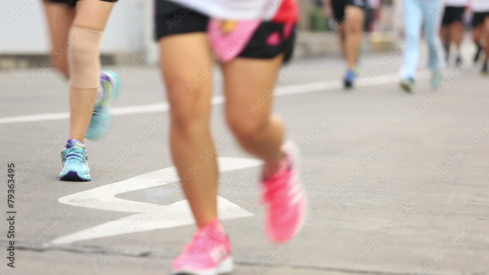 Marathon runners legs on the street Marathon runners legs on the street