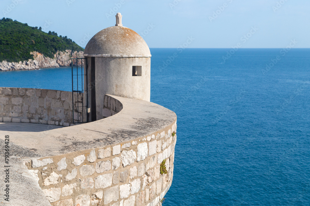 Gun turret on old city walls of Dubrovnik (Croatia) with Adriatic sea in background.