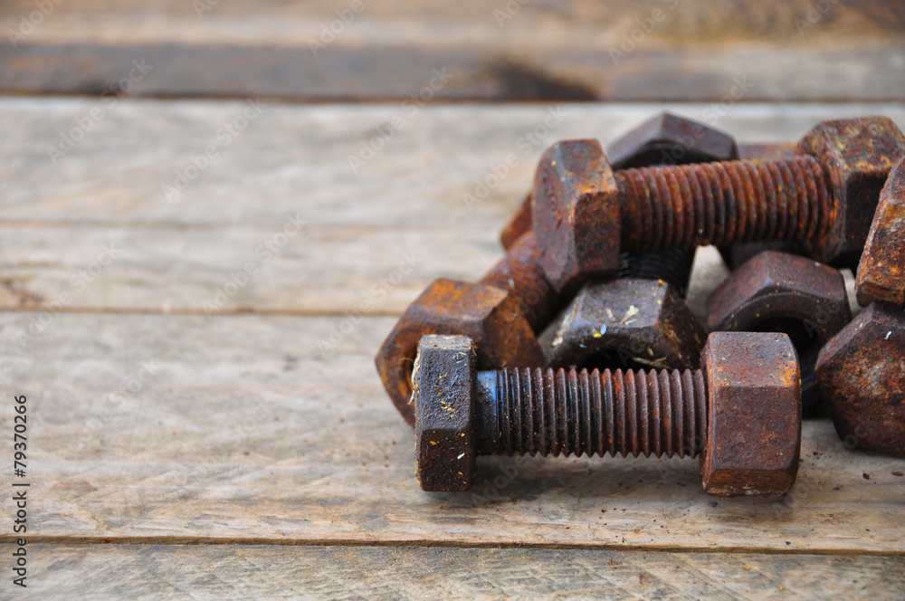 Old bolts or dirty bolts on wooden background Old bolts or dirty bolts on wooden background