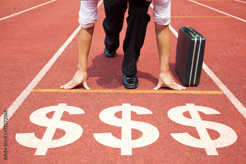 businessman getting ready for race on the track