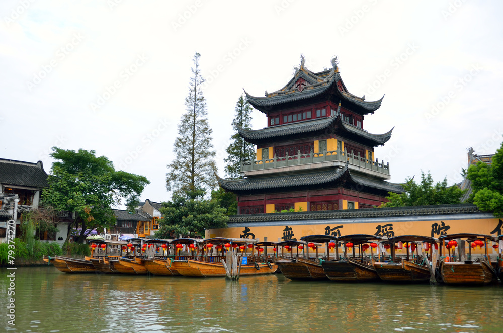 Naklejka premium Old village by river in Shanghai with boat..