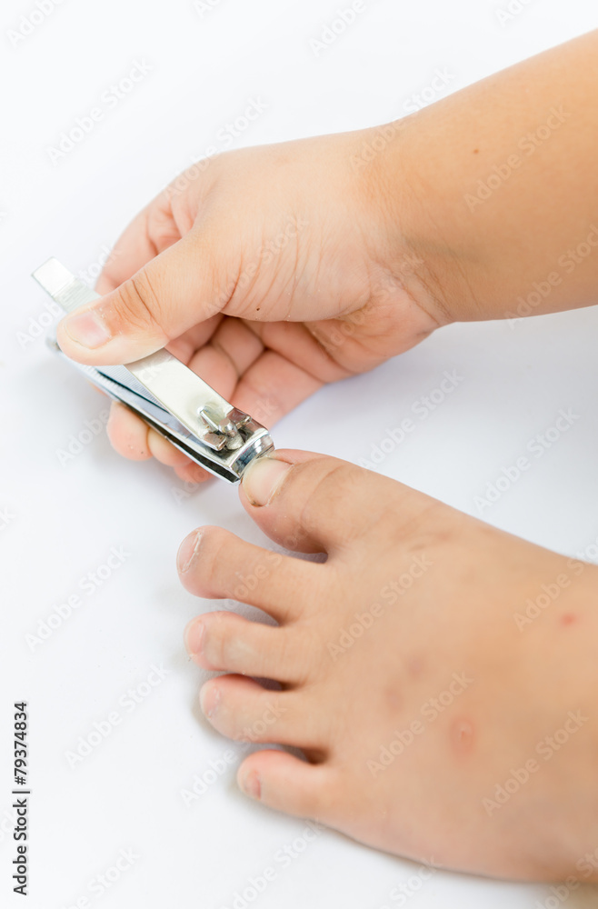 Little hand cutting his toenails on white background Little hand cutting his toenails on white background