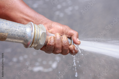 Street sprayed clean with pressurized water, wet cleaning of str