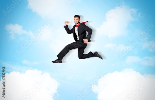 Wallpaper Mural Business person jumping over clouds in the sky Torontodigital.ca