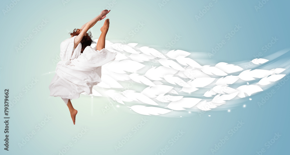 Healthy young woman jumping with feathers around her Healthy young woman jumping with feathers around her