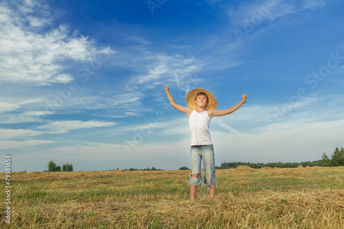 Portrait of happy teenage farmer on field