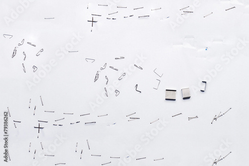 White piece of paper with staple needles. photo