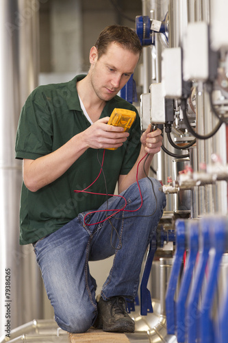 Male technician repairing agriculture machinery