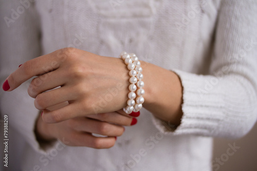 Pearl bracelet on her arm