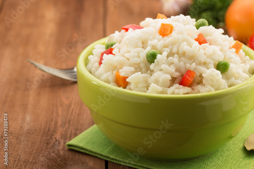 bowl full of rice isolated on wood