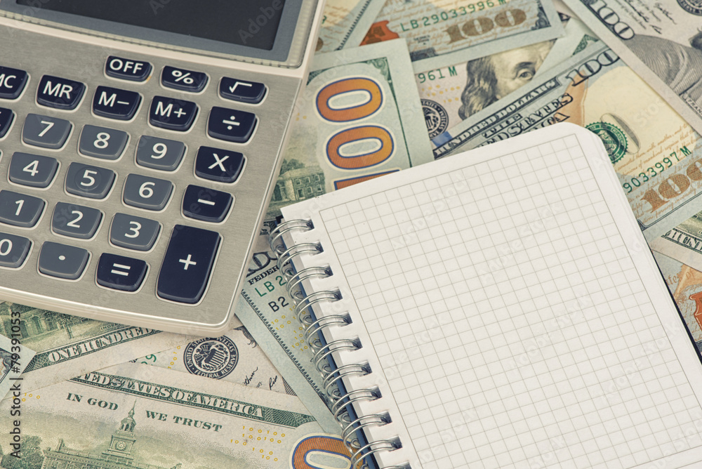 calculator and notepad lying on banknotes calculator and notepad lying on banknotes