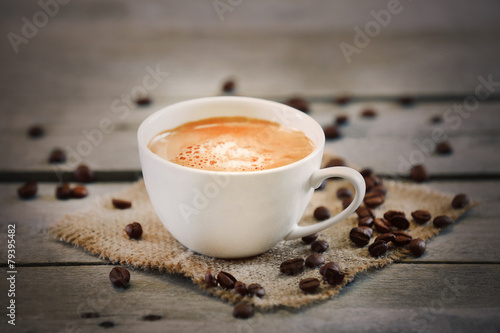 Cup of coffee on wooden table, close up © Africa Studio