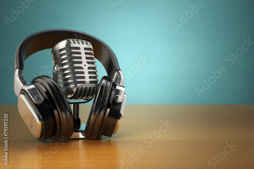 Vintage microphone and headphones on green background. Concept a