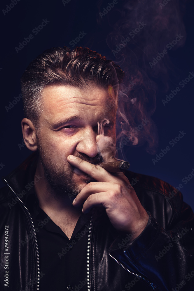 Portrait of a tough guy smoking cigar Portrait of a tough guy smoking cigar