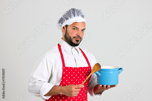 Cook is Holding Spoon and Blue Pot photo