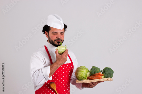 Chiefcook is Holding Tray of Vegetables and Smells a Cole photo