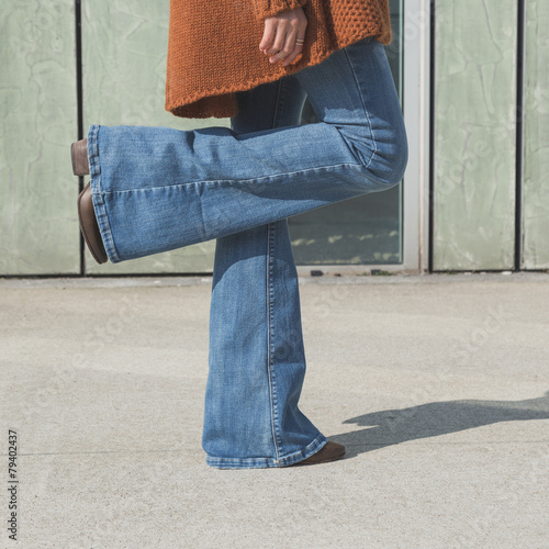 Detail of a girl posing in an urban context