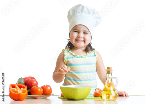 toddler girl preparing healthy food in the kitchen
