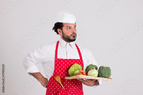 Italian Chiefcook in Red Apron is Holding Wicker Tray with Veget photo