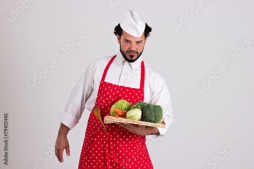 Italian Headcook Holds a Tray with Vegetables photo