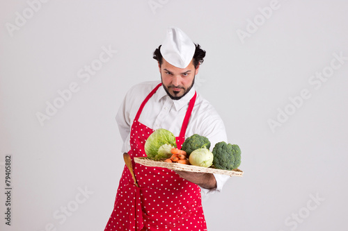 Handsome Headcook is Holding a Wicker Tray with Vegetables photo