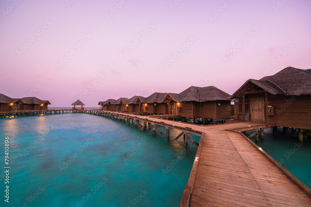 Over water bungalows with steps into amazing green lagoon