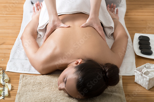 Woman Receiving Back Massage in Spa Center photo