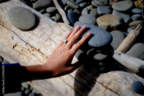 Engagement diamond ring on a pebble beach