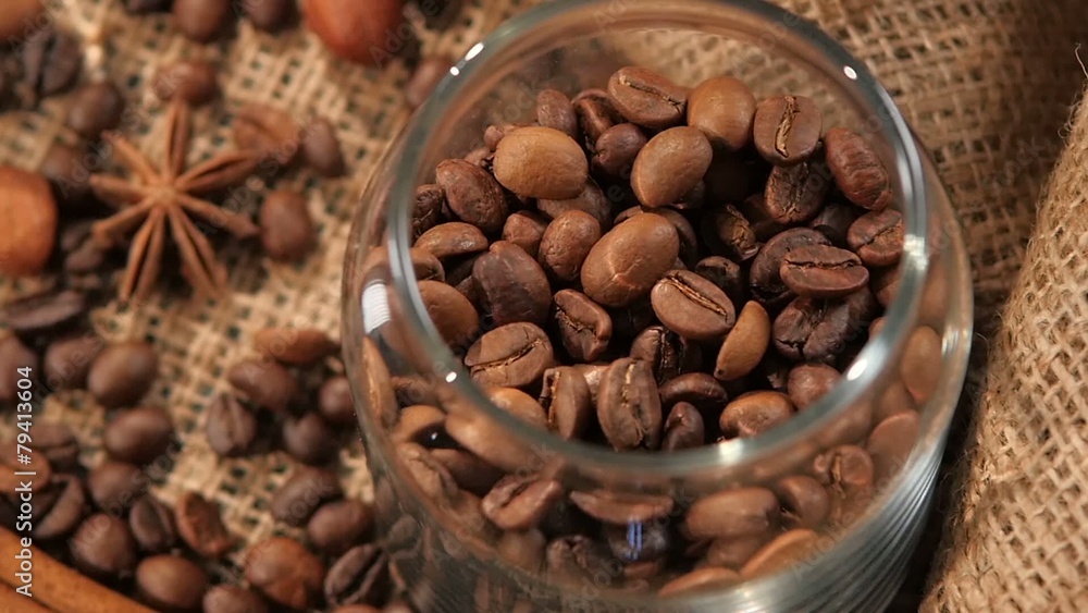 Top of pouring coffee beans into a bottle on background with Top of pouring coffee beans into a bottle on background with