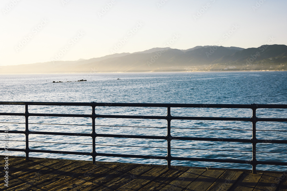 Fence on the Santa Monica Pier and view of mountains and the Pac