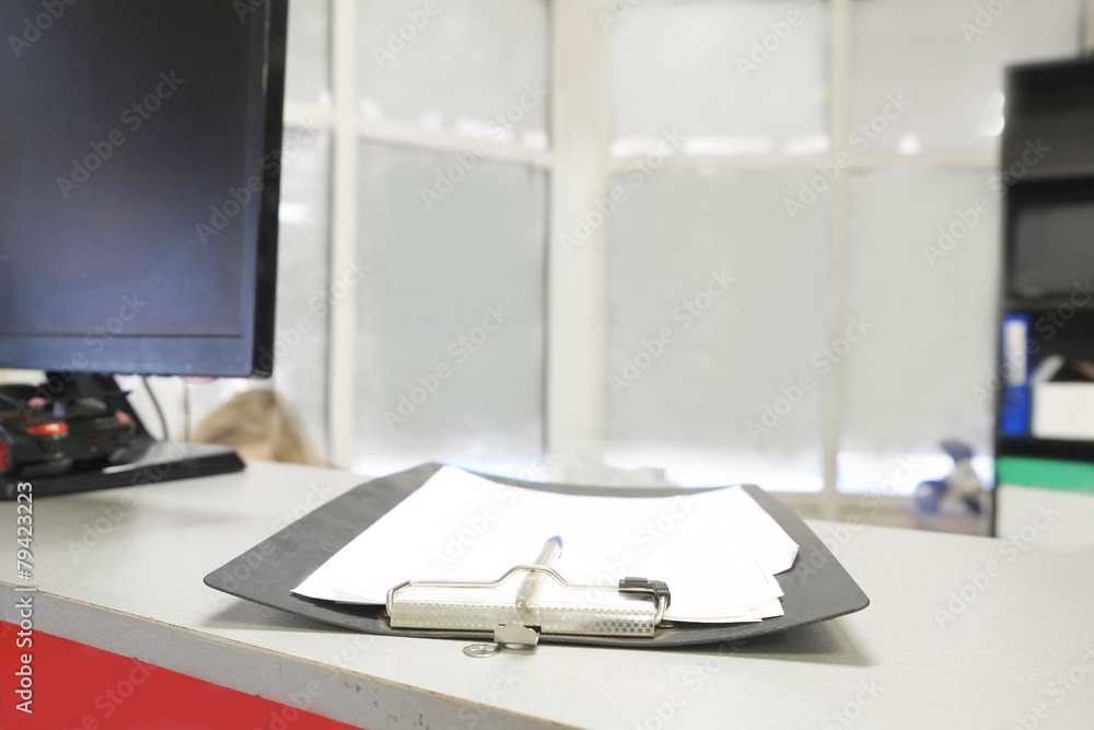 Black clipboard with paper sheet and pen on the table Black clipboard with paper sheet and pen on the table