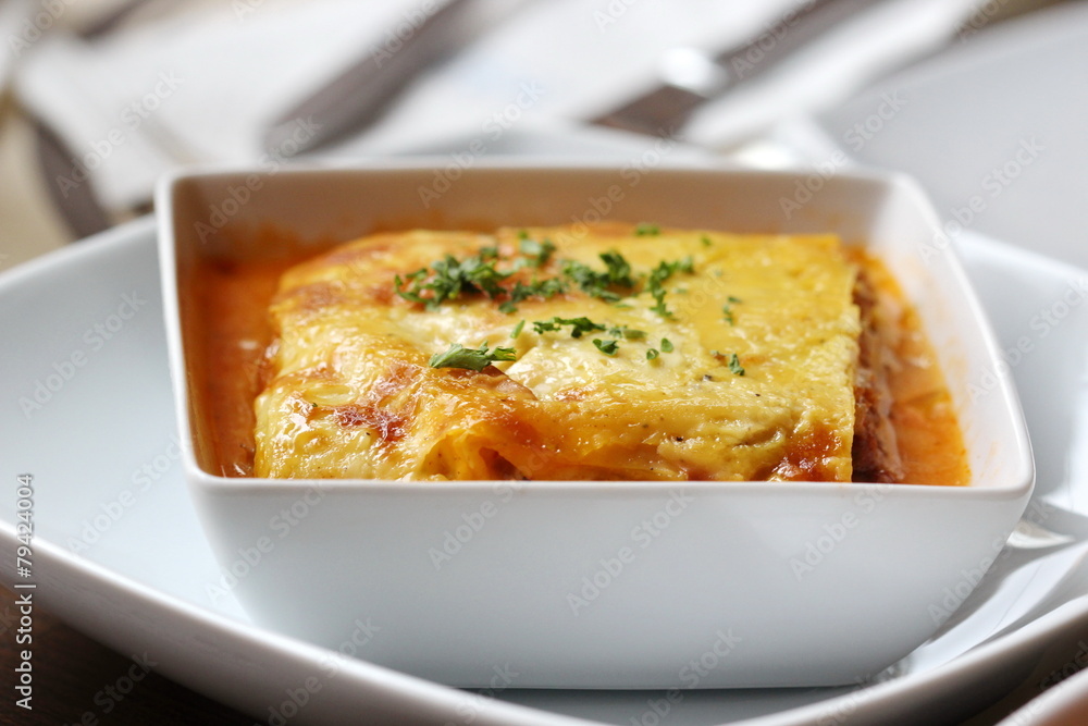 italian lasagna on a square plate italian lasagna on a square plate
