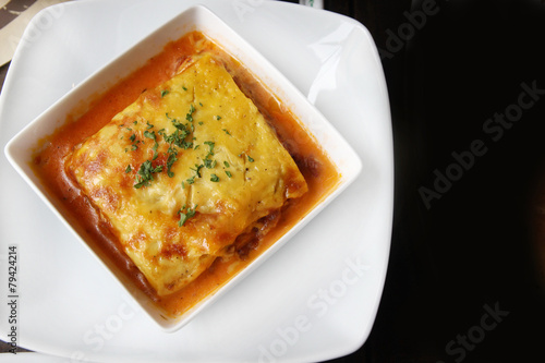 italian lasagna on a square plate