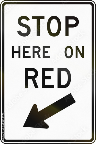 United States traffic sign: Stop here on red sign photo