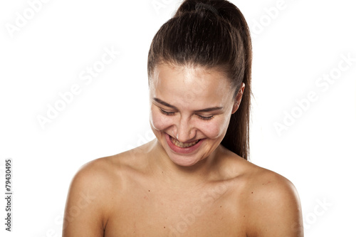 smiling young woman without makeup on white background