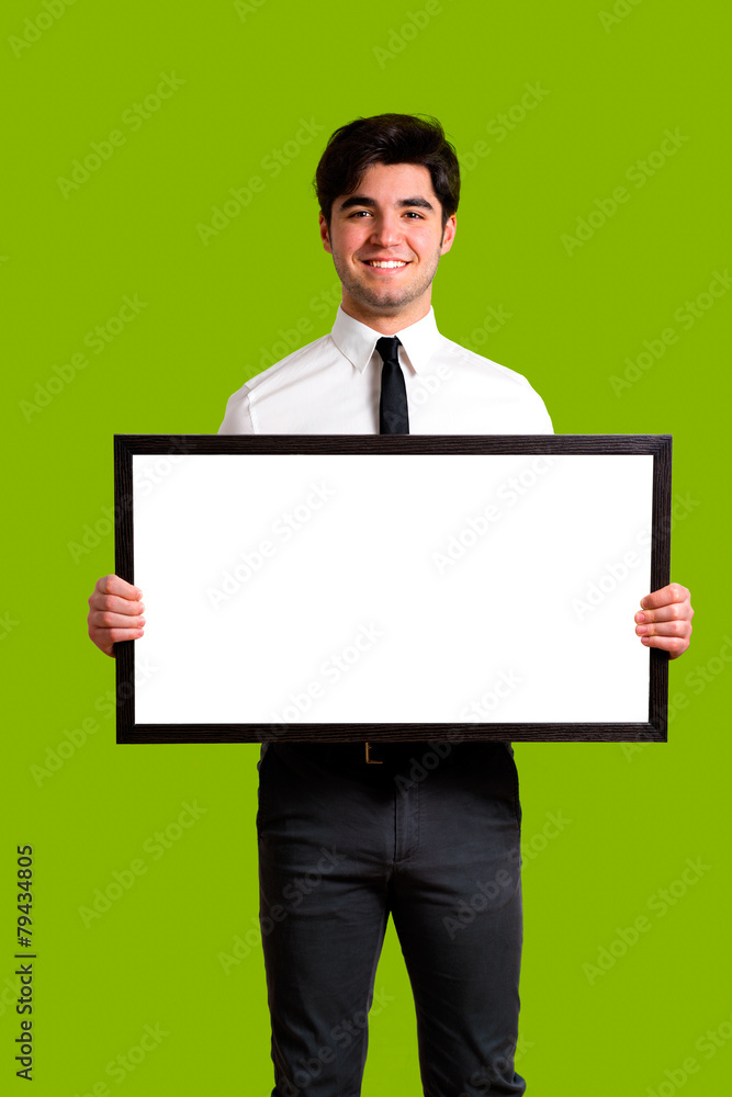young elegant guy holding white board, green background young elegant guy holding white board, green background
