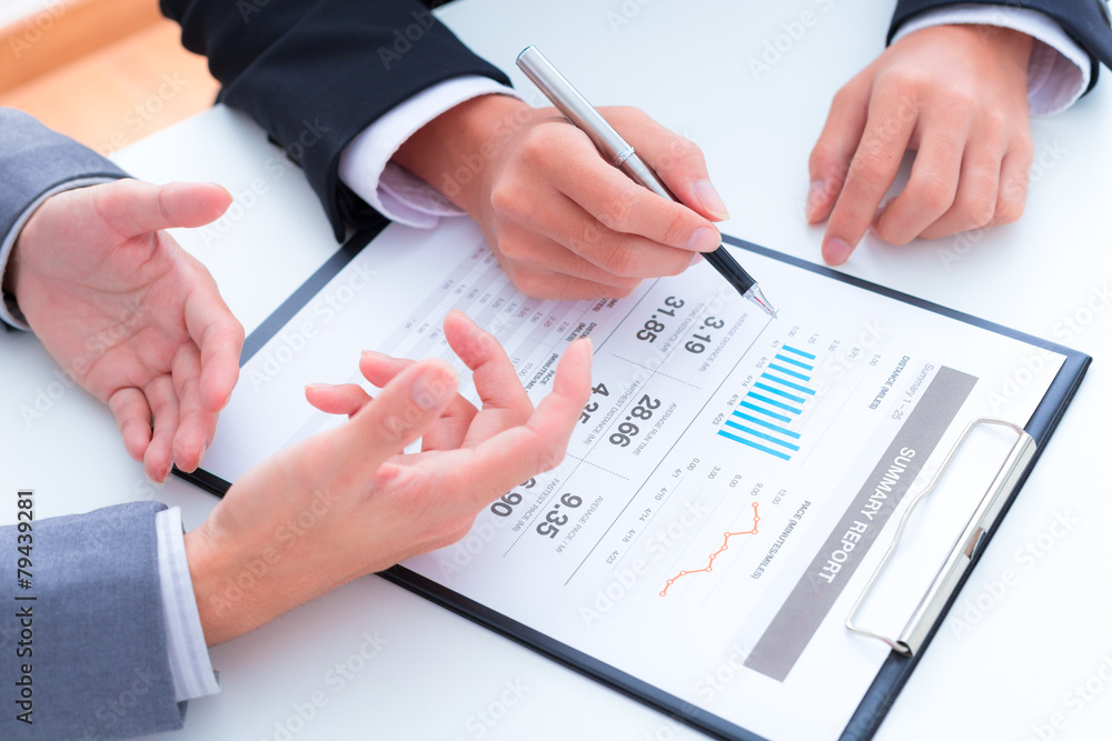 Business people discussing the charts and graphs showing the res Business people discussing the charts and graphs showing the res