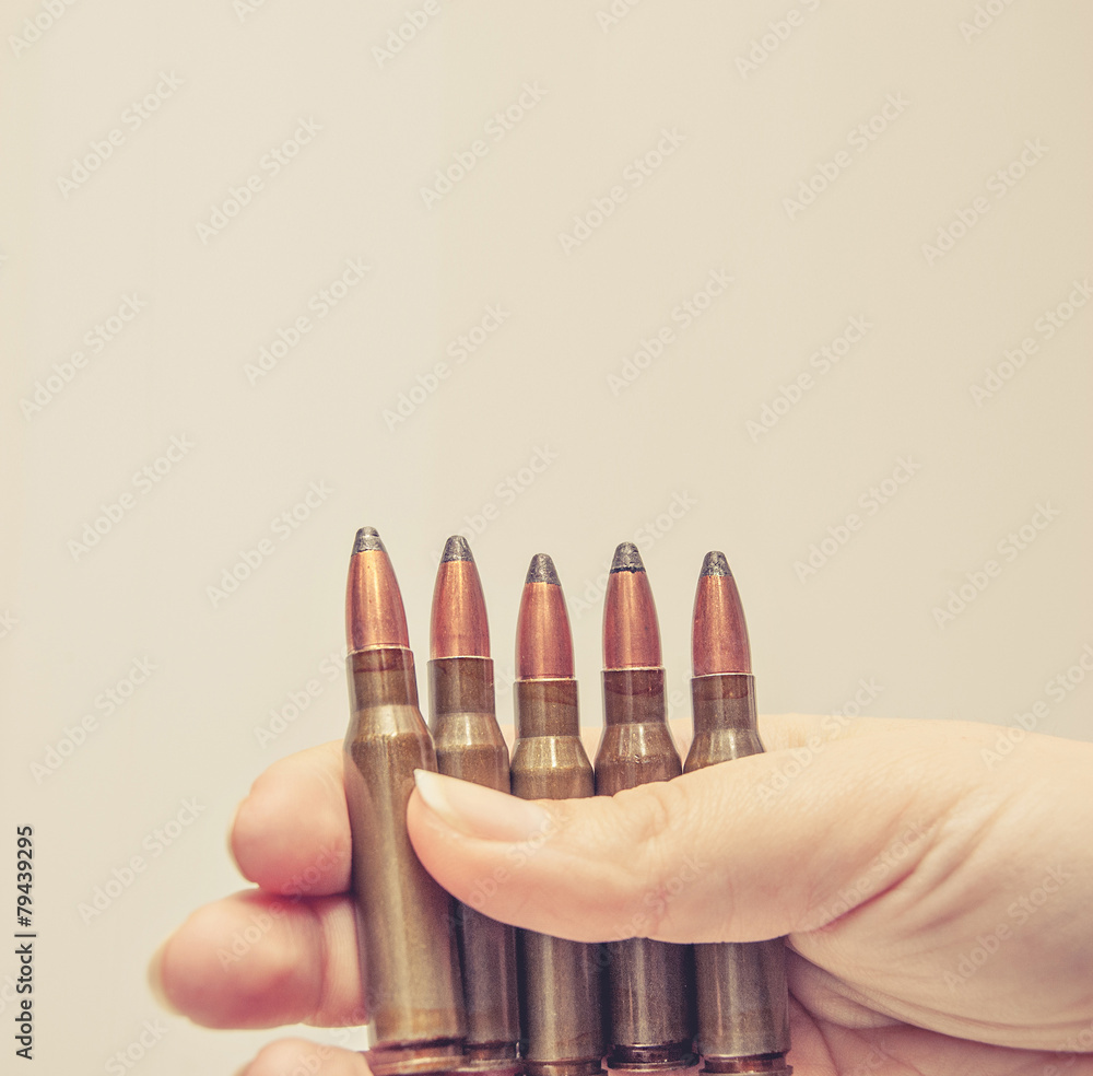 Sport ammo in women hand and a lot of copyspace